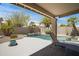 Covered patio area overlooking the backyard, pool, and lush landscaping at 4207 E Rockledge Rd, Phoenix, AZ 85044