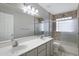 Neutral bathroom featuring a double vanity and shower over tub at 4207 E Rockledge Rd, Phoenix, AZ 85044