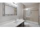 Neutral bathroom featuring a framed mirror, granite countertop, and shower over tub at 4207 E Rockledge Rd, Phoenix, AZ 85044
