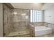 Shower and separate soaking tub, as well as stylish tile, make for a comfortable bathroom at 4207 E Rockledge Rd, Phoenix, AZ 85044