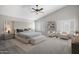 A well-staged bedroom showcases vaulted ceiling, plantation shutters, and calming décor at 4207 E Rockledge Rd, Phoenix, AZ 85044