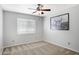 Neutral bedroom featuring carpet, a ceiling fan and modern art at 4207 E Rockledge Rd, Phoenix, AZ 85044