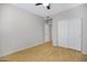Simple bedroom featuring wood floors, a ceiling fan, and closet at 4207 E Rockledge Rd, Phoenix, AZ 85044