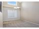 Open dining room featuring large windows, vaulted ceilings, and a modern chandelier at 4207 E Rockledge Rd, Phoenix, AZ 85044