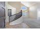 Spacious entryway with curved staircase and large windows providing natural light at 4207 E Rockledge Rd, Phoenix, AZ 85044