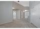 Neutral hallway featuring carpet, with a ceiling fan and multiple doors at 4207 E Rockledge Rd, Phoenix, AZ 85044