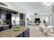 Modern kitchen with stainless steel appliances, dark cabinetry, and an open layout to the living area at 4207 E Rockledge Rd, Phoenix, AZ 85044