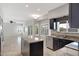 Open concept kitchen with dark cabinets, light countertops, and stainless steel appliances at 4207 E Rockledge Rd, Phoenix, AZ 85044