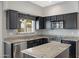 Updated kitchen with dark cabinets, stainless steel appliances, and bright granite countertops at 4207 E Rockledge Rd, Phoenix, AZ 85044
