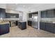 Spacious kitchen featuring stainless steel appliances, dark cabinets, and a center island at 4207 E Rockledge Rd, Phoenix, AZ 85044