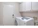 Laundry room featuring new washer and dryer, white cabinets, and a door to the outside at 4207 E Rockledge Rd, Phoenix, AZ 85044