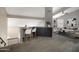 Open living room with a wet bar, carpet and a ceiling fan at 4207 E Rockledge Rd, Phoenix, AZ 85044