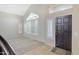 Inviting living room with neutral colors, tile entryway, and large windows at 4207 E Rockledge Rd, Phoenix, AZ 85044