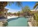 Backyard swimming pool with rock accents, mature landscaping, and a private outdoor space at 4207 E Rockledge Rd, Phoenix, AZ 85044