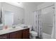 Bathroom with vanity, sink, toilet, and shower/tub combo at 44175 W Knauss Dr, Maricopa, AZ 85138