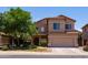 Charming two-story home with a well-maintained front yard and attached two-car garage at 44175 W Knauss Dr, Maricopa, AZ 85138