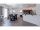 Eat-in kitchen features a dark wood table and a stainless-steel fridge and appliances at 44175 W Knauss Dr, Maricopa, AZ 85138