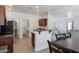 Bright eat-in kitchen featuring modern stainless-steel appliances and an open-concept layout at 44175 W Knauss Dr, Maricopa, AZ 85138