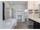 Bright main bathroom features a soaking tub, a glass-enclosed shower, and a walk-in closet at 44175 W Knauss Dr, Maricopa, AZ 85138