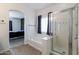 Bathroom showcases tub and separate shower with glass door and dark blue curtain at 44175 W Knauss Dr, Maricopa, AZ 85138