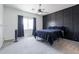 Comfortable main bedroom featuring a ceiling fan, blackout curtains and a black accent wall at 44175 W Knauss Dr, Maricopa, AZ 85138