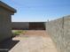 An exterior image of the backyard featuring a block wall and gate at 4624 S 19Th Ave, Phoenix, AZ 85041