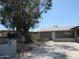 Charming single-story home featuring mature tree and concrete driveway, providing ample parking space at 4624 S 19Th Ave, Phoenix, AZ 85041