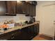 Well-equipped kitchen featuring stainless steel sink, dark wood cabinets, and granite countertops at 4624 S 19Th Ave, Phoenix, AZ 85041