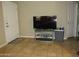 Living room featuring a flat-screen television, adjacent to door, showcasing a minimalist design at 4624 S 19Th Ave, Phoenix, AZ 85041