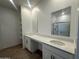 Modern bathroom with double sinks, quartz countertops, and a walk-in shower with glass door at 47230 W Cansados Rd, Maricopa, AZ 85139
