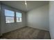 Bright bedroom with plush carpet, large windows and neutral walls at 47230 W Cansados Rd, Maricopa, AZ 85139