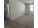 Spacious bedroom with neutral carpet, white walls, window with blinds, and doorway at 47230 W Cansados Rd, Maricopa, AZ 85139