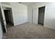 Bedroom with neutral carpet, sliding closet doors, white walls, and doorway at 47230 W Cansados Rd, Maricopa, AZ 85139
