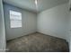 Cozy bedroom with plush carpeting, large windows, and neutral color palette at 47230 W Cansados Rd, Maricopa, AZ 85139