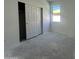 Bedroom with sliding closet doors and a bright window at 47230 W Cansados Rd, Maricopa, AZ 85139