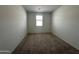 Bright bedroom with neutral carpet, a window with blinds, and white walls at 47230 W Cansados Rd, Maricopa, AZ 85139