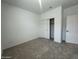 Cozy bedroom featuring neutral carpet, closet, and natural light from windows at 47230 W Cansados Rd, Maricopa, AZ 85139