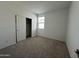 Bedroom features neutral carpet, white walls, window with blinds, and closet with sliding doors at 47230 W Cansados Rd, Maricopa, AZ 85139