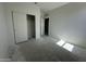 Bedroom featuring white walls, closet, and door to other room in a new construction at 47230 W Cansados Rd, Maricopa, AZ 85139