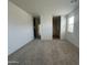 Bonus room with neutral carpet, access to additional rooms, and one window with blinds at 47230 W Cansados Rd, Maricopa, AZ 85139