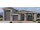A charming single-Gathering home features a two-car garage, neutral color palette and well manicured desert landscaping at 47230 W Cansados Rd, Maricopa, AZ 85139