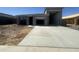 New construction featuring a gray single-Gathering home with a concrete driveway and garage at 47230 W Cansados Rd, Maricopa, AZ 85139