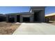 Contemporary gray single-story home features two garages and a concrete driveway at 47230 W Cansados Rd, Maricopa, AZ 85139