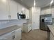 Modern kitchen featuring white cabinetry, stainless steel appliances, and wooden floors at 47230 W Cansados Rd, Maricopa, AZ 85139