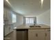Modern kitchen boasts a large island with a sink and stainless steel appliances at 47230 W Cansados Rd, Maricopa, AZ 85139