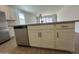 Contemporary kitchen with stainless steel dishwasher, island with bar seating and wood floors at 47230 W Cansados Rd, Maricopa, AZ 85139