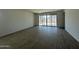 Spacious living room with wood-style flooring and sliding glass doors to the backyard at 47230 W Cansados Rd, Maricopa, AZ 85139