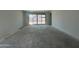 Bright living room featuring sliding glass doors to the backyard at 47230 W Cansados Rd, Maricopa, AZ 85139
