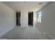 An unfurnished living space with several doorways and a bright window at 47230 W Cansados Rd, Maricopa, AZ 85139