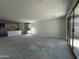 Open living area leading to a kitchen and sliding glass doors to the backyard at 47230 W Cansados Rd, Maricopa, AZ 85139